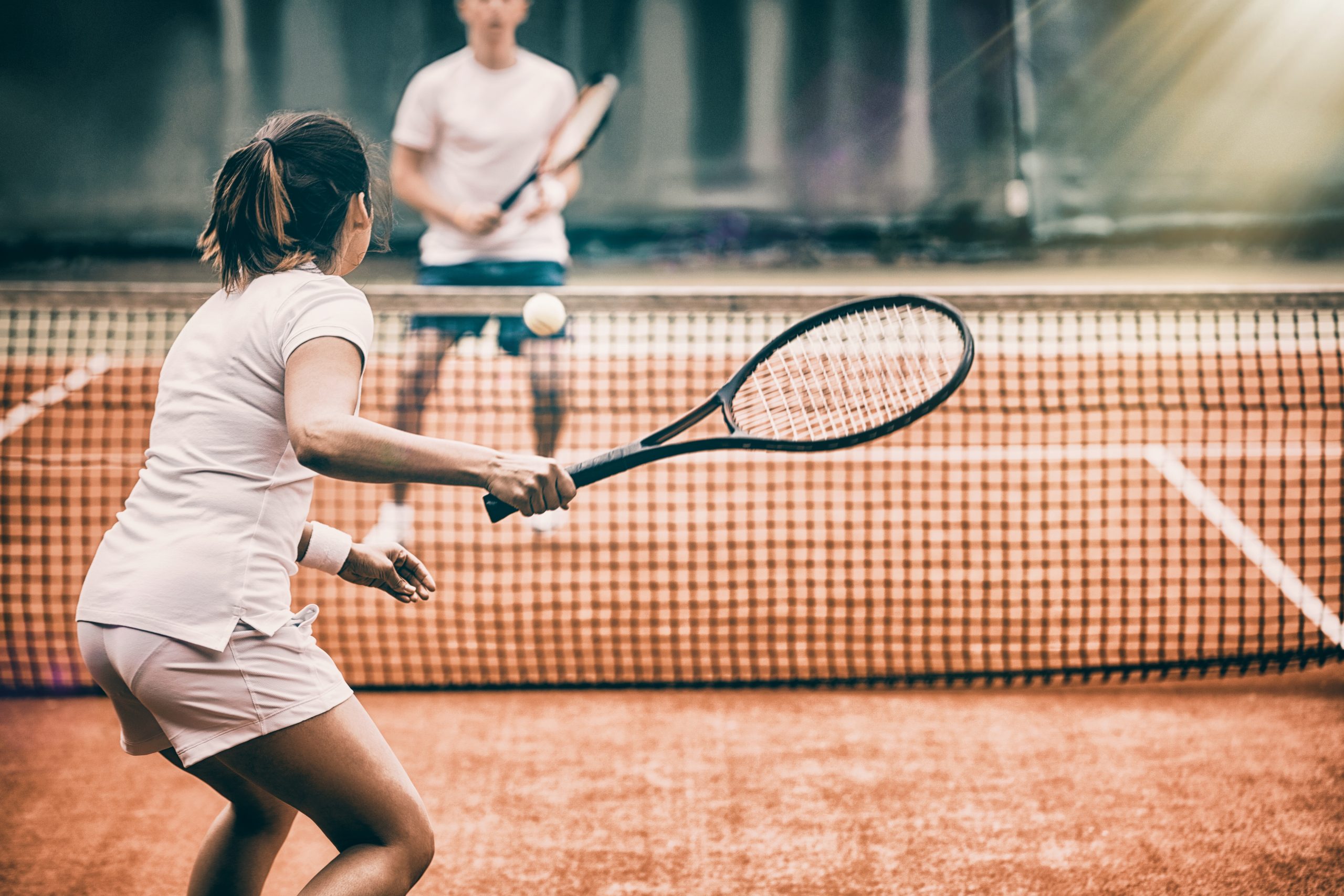 Tennis players playing a match on the court