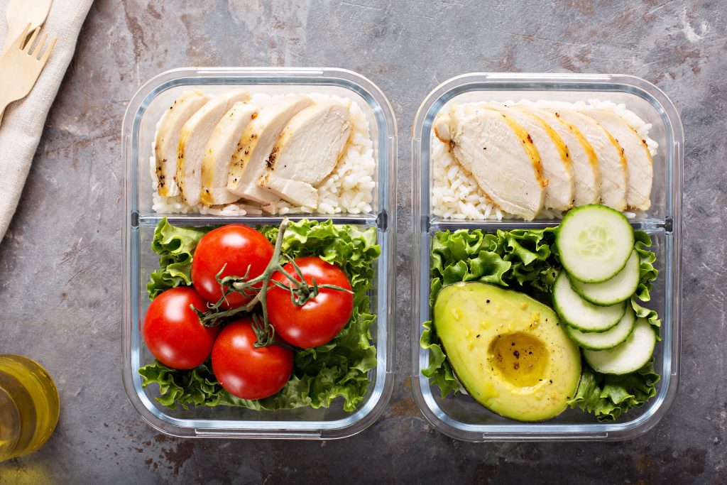 2 glass containers with prepared meals in them