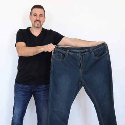 Rob holding jeans in his old size