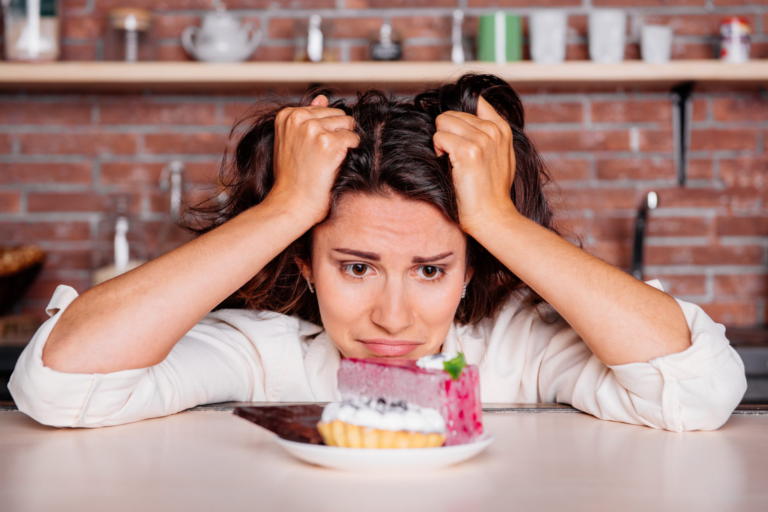 Woman craving to eat cake.