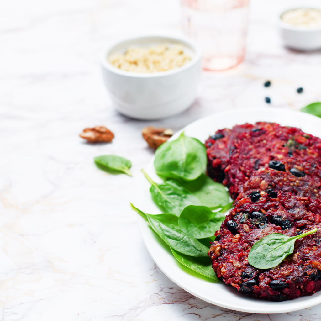 Image with beetroot and bean patties on a plate