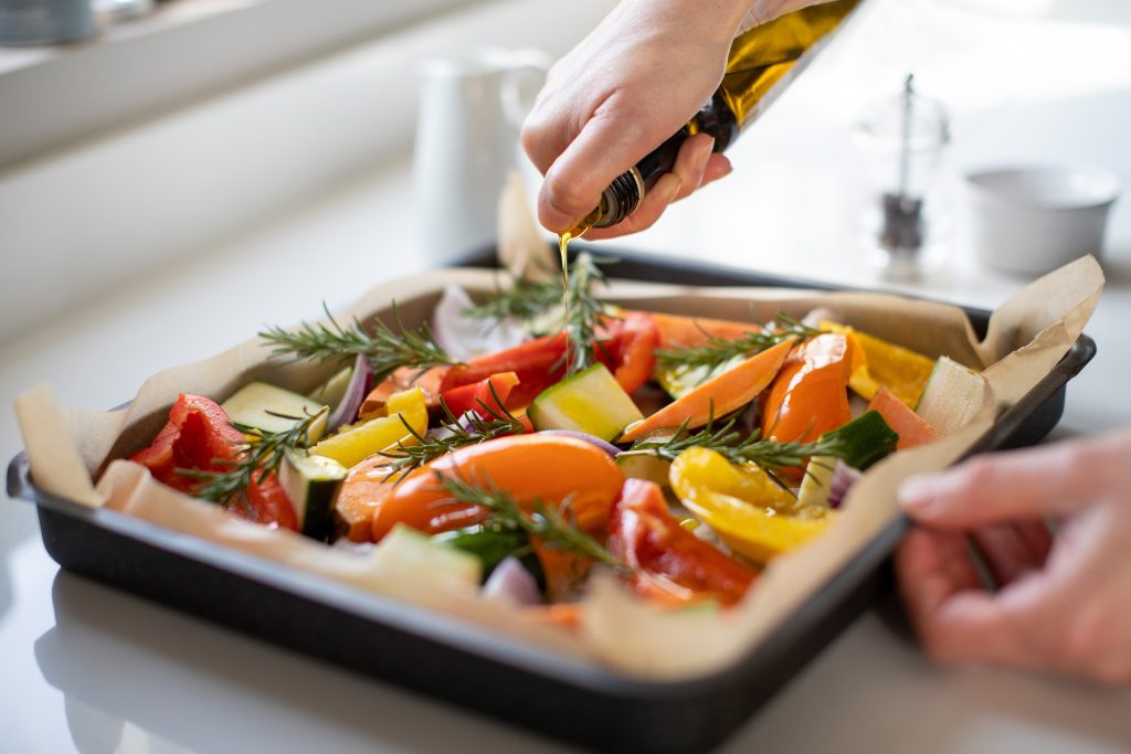 pouring cooking oils on roasted vegetables