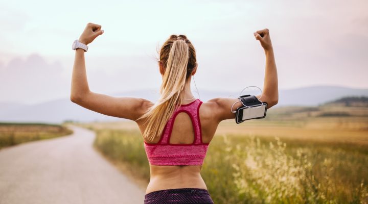 A woman going for a run on a cottage road