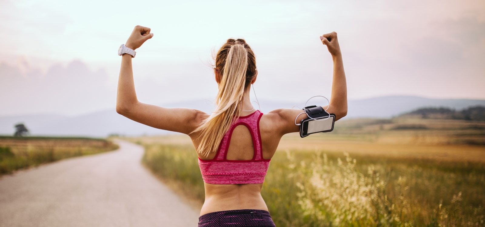 A woman going for a run on a cottage road
